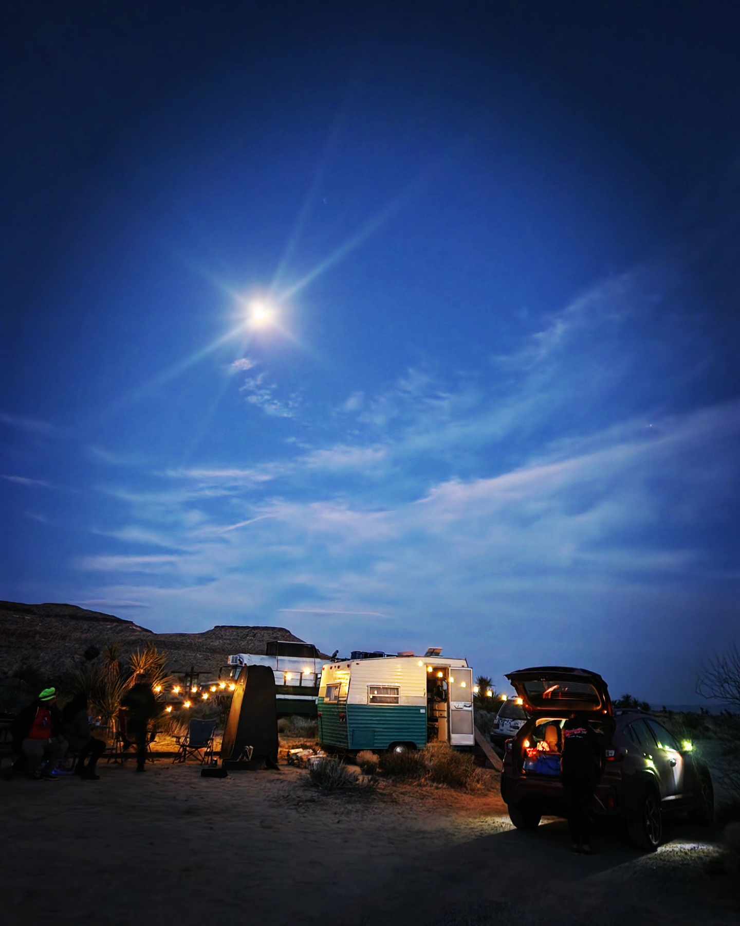 The meme is a picture of a campsite at night, with a campfire, a tent, and a few people sitting around it. The image is captioned "I'm not arguing, I'm just explaining why I'm right."